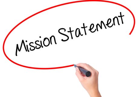 Women Hand writing Mission Statement with black marker on visual screen. Isolated on white. Business, technology, internet concept. Stock Photo